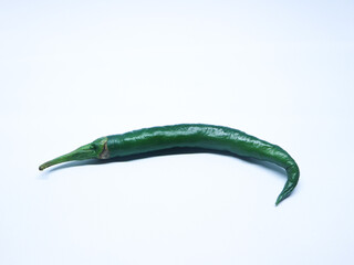 A Single fresh green chilli isolated against white background