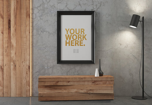 Vertical poster in large black frame mockup hanging on wall in room