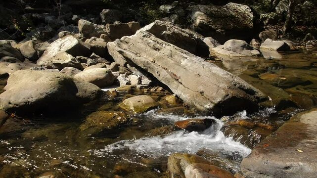 Water cascades past giant boulders in Richland Creek in the Laurel Snow State Natural Area in Tennessee
