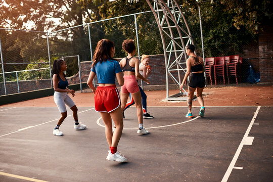 Women, sport and ball on basketball court as player or athlete for challenge as ready for training. Female people, warm up and outdoor for competition, match and game in physical activity or exercise