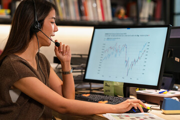 Financial advisor consulting investor make a call and advice of financial trade stock data using laptop computer. She introduce trend of stock in exchange planning investment at office meeting.