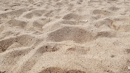 Beautiful sand in the summer day. Sand on the beach near a sea.