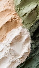 Detailed view of diverse powder pigments in shades of green, beige, and white, showcasing artistic texture and fine granules.