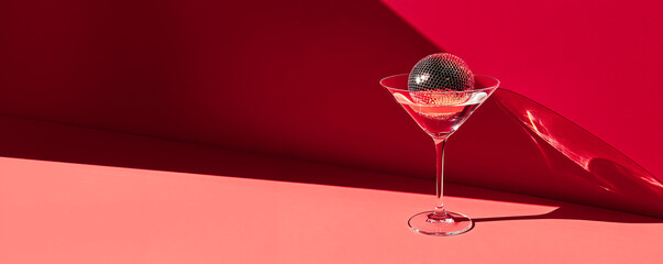 Cocktail party with disco ball on sunset coral color background. Disco party, retro fashion. Modern stylish banner template for holiday card, banner, flyer, menu with space for text