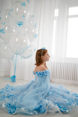 little girl in blue dress with giant helium balloons
