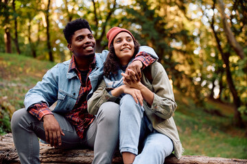 Young embraced couple enjoying in autumn day in nature.