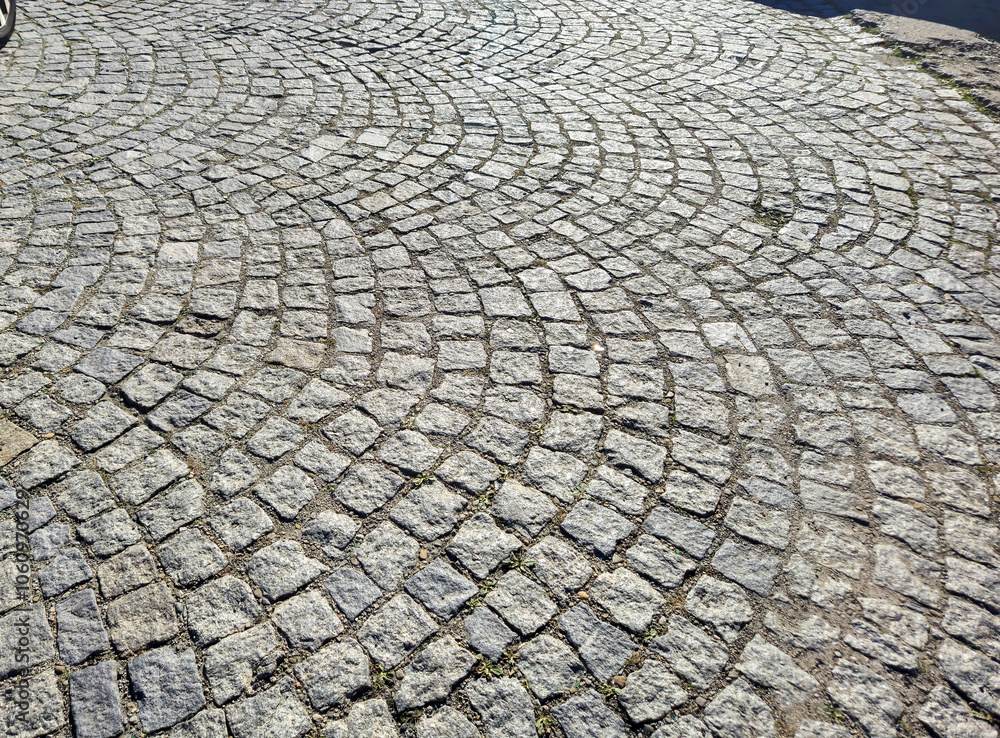 Aufkleber detailed view of cobblestone pavement with a unique wavy pattern highlighting its texture and colors