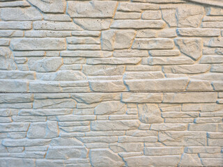 Textured white stone wall background for design projects. Ideal for home decor and architectural contexts.