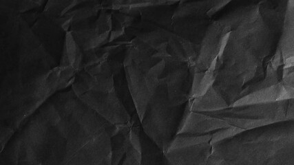 High-resolution black crumpled paper texture with dramatic light and shadow. Ideal for use in backgrounds, overlays, or grunge design projects.. - Powered by Adobe