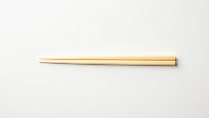 Pair of wooden chopsticks arranged on a white background, showcasing a minimalist style. Everyday things for dining.