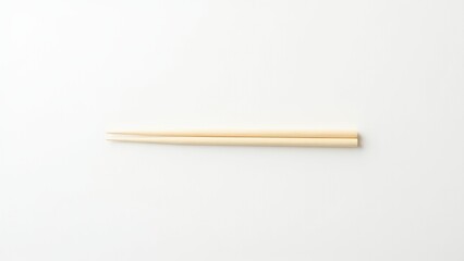 Obraz premium Pair of wooden chopsticks arranged on a white background, showcasing a minimalist style. Everyday things for dining.