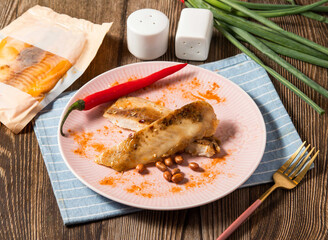 Sichuan Spicy Shufei Snapper fish with red chilli served in plate isolated on napkin side view of taiwan food