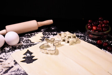 Christmas baking. Gingerbread dough in the shape of a Christmas tree, an angel, a star. Festive...