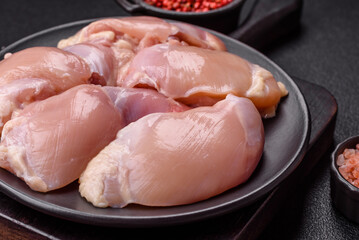 Fresh raw chicken thigh fillets with salt, spices and herbs