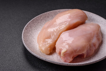 Pieces of raw chicken or turkey fillet with salt, spices and herbs