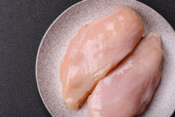 Pieces of raw chicken or turkey fillet with salt, spices and herbs