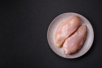 Pieces of raw chicken or turkey fillet with salt, spices and herbs