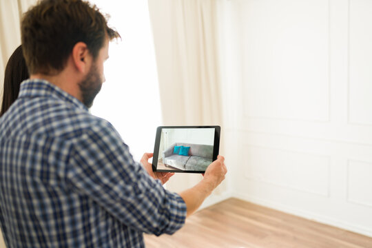 Pair utilizes a digital tablet and augmented reality to plan furniture placement in their new home - Powered by Adobe