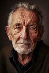 Obraz premium Portrait of Elderly Man with Gentle Expression on Monochrome Lavender Background
