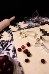 Christmas baking. Gingerbread dough in the shape of a Christmas tree, an angel, a star. Festive...