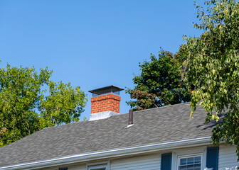 House Rooftop with Brick Chimney and Vent in Brighton, MA, USA
