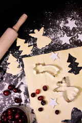 Christmas baking. Gingerbread dough in the shape of a Christmas tree, an angel, a star. Festive atmosphere.