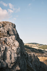 Beautiful mountain landscape with people hiking under the sun 