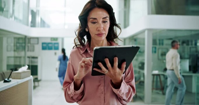 Hospital, walking and woman with tablet, healthcare and scheduling of appointment, receptionist and online. Digital, reading and person with information on app, administration and medical coder