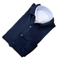 set of dark blue button down cardigan and light blue folded shirt, isolated on white background