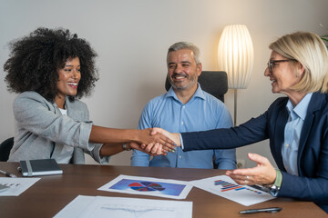 Business people shaking hands. Business people shaking hands, finishing up a meeting. Smiling...