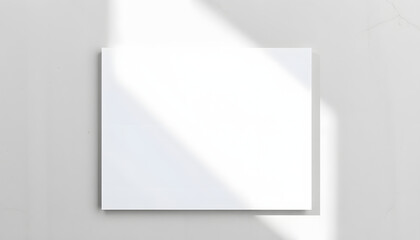 Fototapeta premium Close up of empty white rectangle poster or card mockups lying diagonally with soft shadow on neutral light grey textured background. Flat lay, top view. Open composition isolated with white highlig