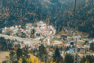 Obraz premium View from Mount Mussa-Achitara to the village of Dombay and the cable car. Dombay is the most famous ski resort and the center of mountaineering and tourism in the Caucasus.