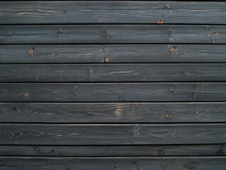Fototapeta premium Dark wooden planks arranged evenly on a wall surface indoors