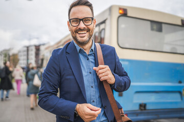 Portrait of businessman wait transportation on the bus station