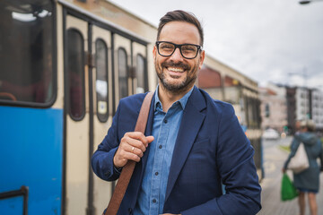 Portrait of businessman wait transportation on the bus station