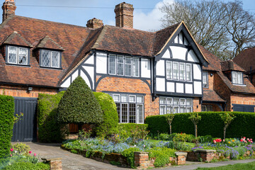 Walking on streets of North London, red brick houses and flowering gardens in spring, city life,...