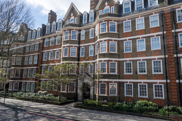Fototapeta premium Red bricks houses on Hans Crescent street in Royal Borough of Kensington and Chelsea, London, UK