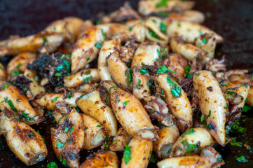 Assortment of fresh daily catch of prawns, seashells, molluscs on ice on fish market in Brittany, France, English translation: differens French names of seafood