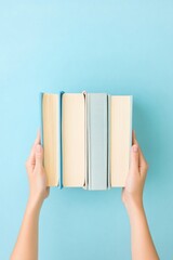 A person holding two books together.