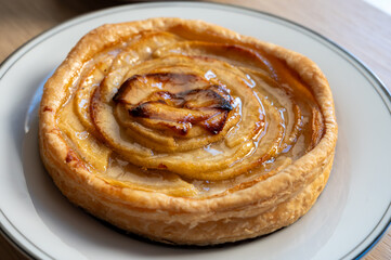 French fresh baked sweet puff pastry with fresh apple fruits in sirup  in confectionery shop