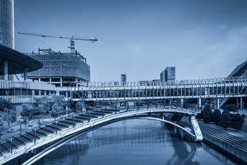 Modern Urban Landscape Featuring Pedestrian Bridge and Construction Site
