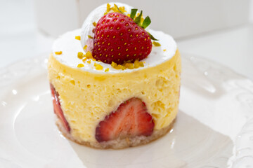 Red fruit sweet dessert cheesecake tart with fresh strawberries in bakery