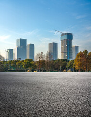 Fototapeta premium Modern Urban Skyline with New Construction and Autumn Trees