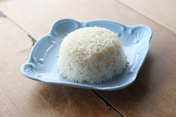plate of cooked rice on wood table.