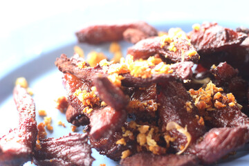 Fried beef with garlic on a plate