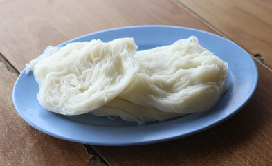 plate of rice vermicelli on wood table.