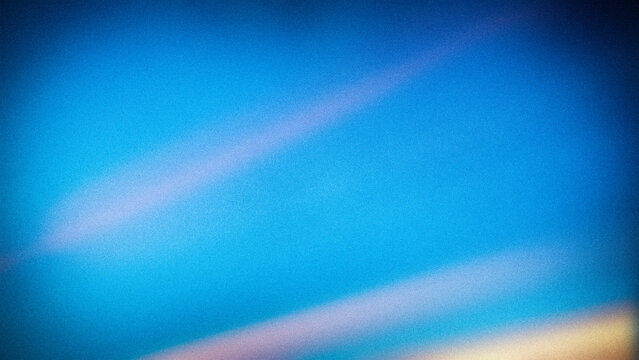 Abstract gradient background with rich blue tones accented by soft pink and yellow streaks, grainy texture adds depth, ideal for creative digital designs