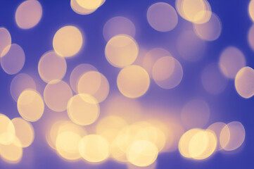 Soft, warm bokeh lights on a cool blue background, creating a dreamy and festive ambiance.