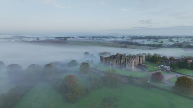 Raglan Castle in the fog at dawn, Monmouthshire, Wales, England