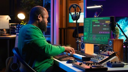 Artist playing electronic piano keyboard notes and recording audio files to use mix and master...